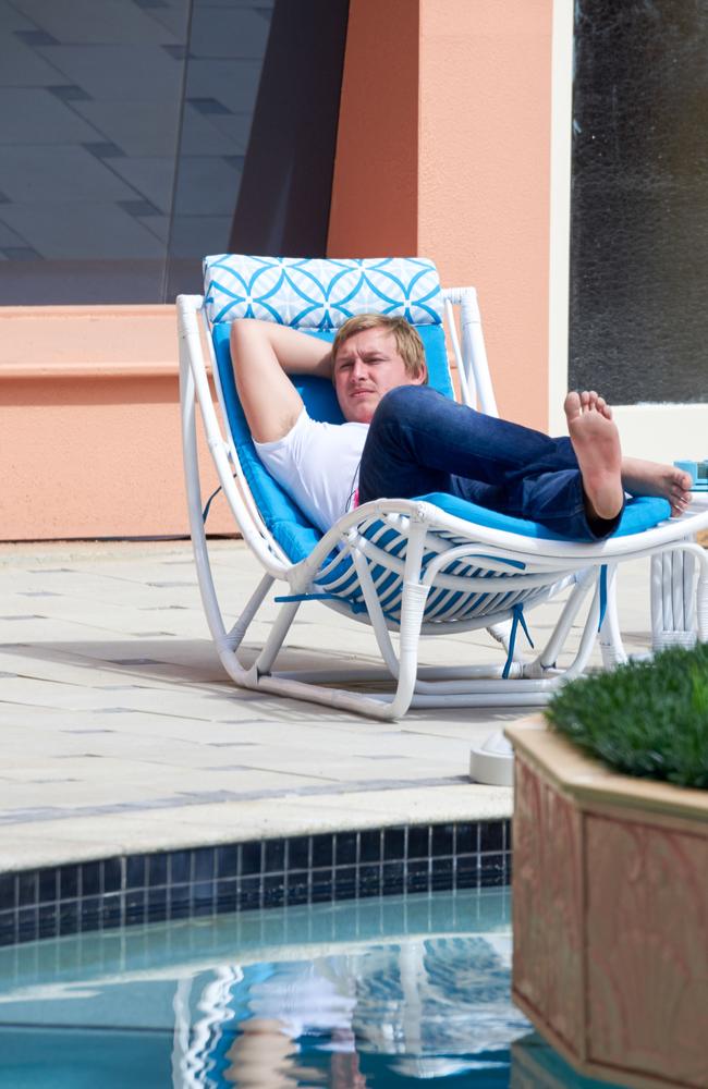 Former Gold Coast Bulletin reporter Jack Houghton reclines near the site which has been reportedly smashed. 