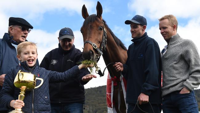 Melbourne Cup winner Almandin with (left to right) owner Lloyd Williams with his grandson Frank holding the cup, trainer Rob Hickmott, Joel Flannery and jockey Kerrin McEvoy at Macedon Lodge.