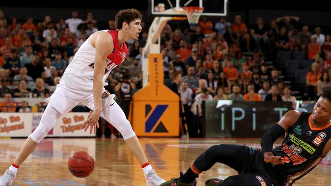 Hawks LaMelo Ball runs around Taipans Scott Machado who slips during the Round 6 NBL match between Cairns Taipans and Illawarra Hawks at the Cairns Convention Centre in Cairns, Saturday, November 9, 2019. (AAP Image/Marc McCormack)