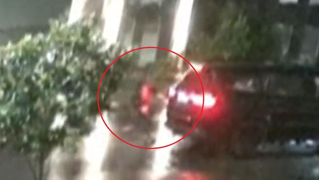 One of the two men is seen racing back to the vehicle shortly after the alleged shooting. Picture: Supplied / Channel 9
