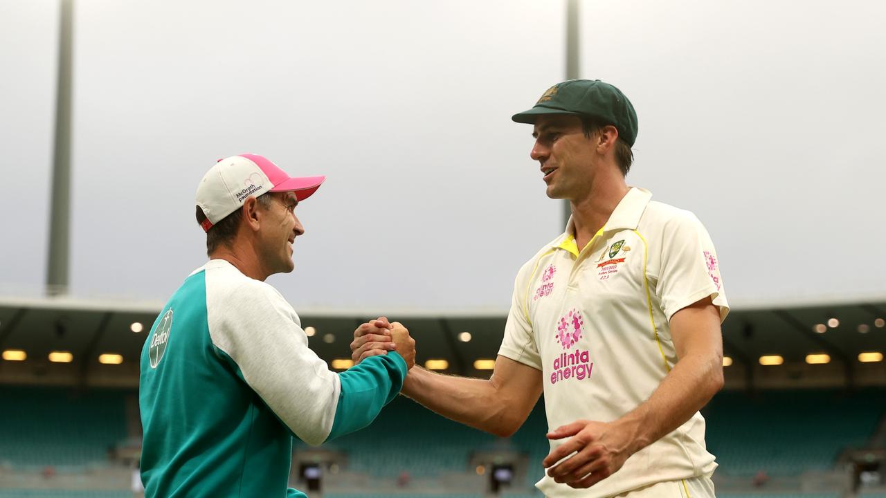 SYDNEY, AUSTRALIA – JANUARY 09: Head coach Justin Langer shakes hands with Pat Cummins of Australia after the match ended in a draw on day five of the Fourth Test Match in the Ashes series between Australia and England at Sydney Cricket Ground on January 09, 2022 in Sydney, Australia. (Photo by Mark Kolbe/Getty Images)