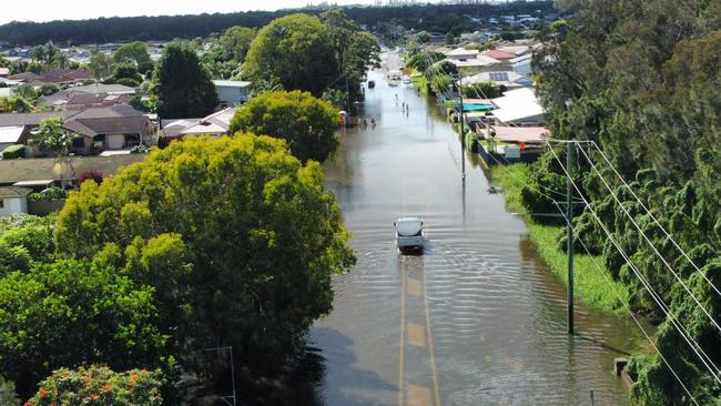 Carrs Drive at Yamba still covered in water on Wednesday morning as residents start cleaning up.