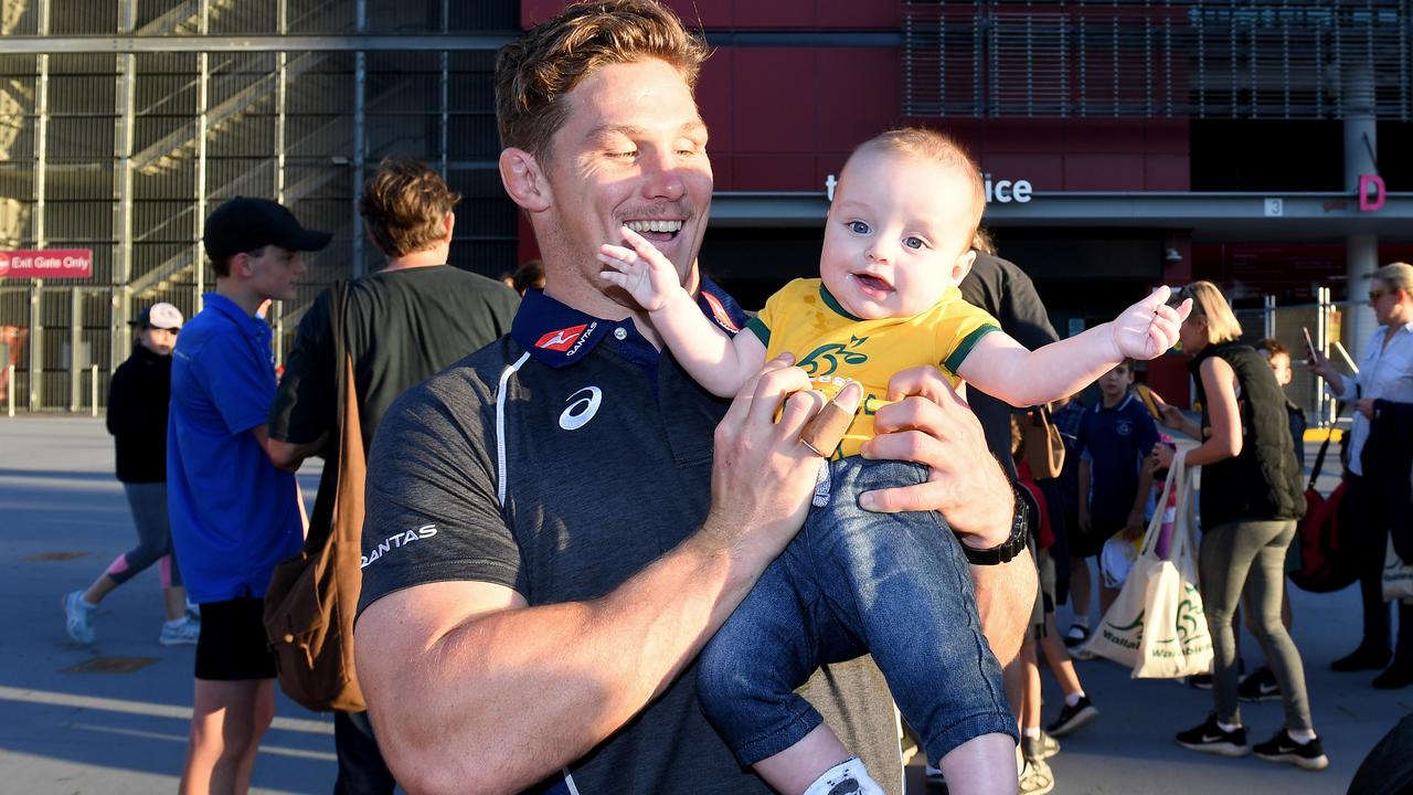 Michael Hooper holds five month old baby Charlie Wollen.