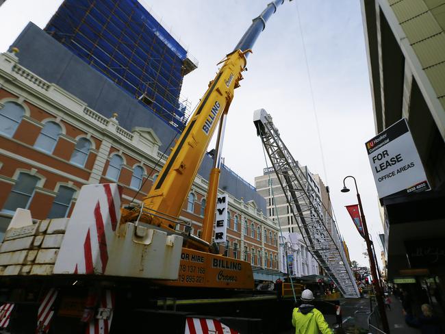 Two cranes lifting a large section of another crane in Hobart’s CBD last month. Picture: MATT THOMPSON