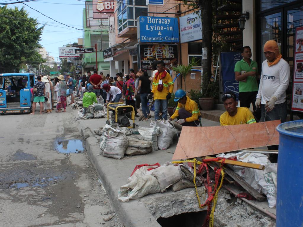 Workers work on the drainage system in Boracay’s business centre. Picture: AFP