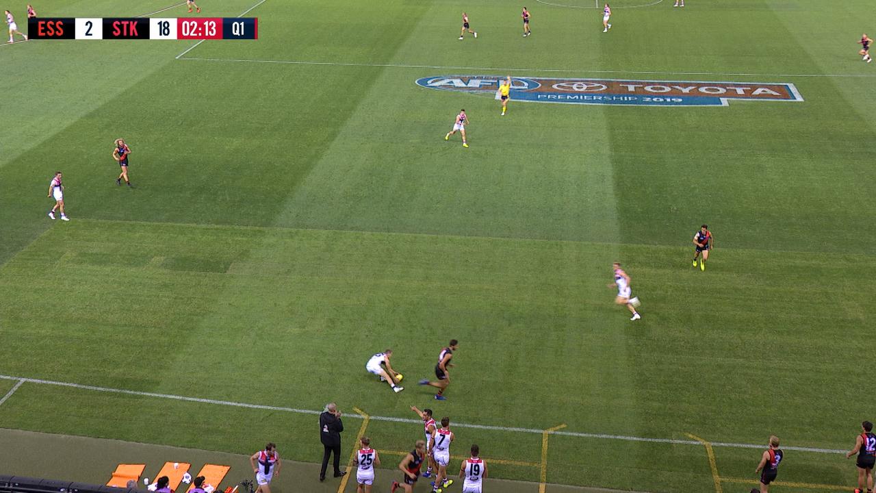 Kyle Langford and Matt Guelfi head off the ground, ignoring the footy, during the first quarter of Essendon v St Kilda.