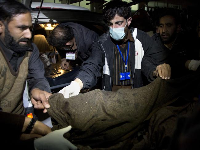 Pakistani volunteers move remains of plane crash victims to a mortuary at a hospital, in Abbottabad, Pakistan, Wednesday, Dec. 7, 2016. Picture: AP Photo/B.K. Bangash