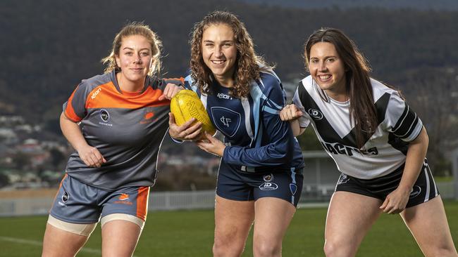 SFLW footballers, from left, Jess Kube (South East Suns), Mandy Fish (Lindisfarne) and Katie Stanford (Claremont) on the eve of the competition kick-off last year. Picture: Chris Kidd