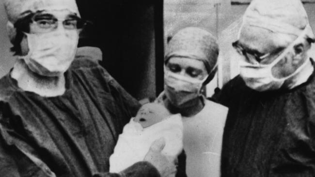 Professor Robert Edwards holding the world’s first IVF baby, Louise Joy Brown, with unnamed midwife and fertility specialist Dr Patrick Steptoe following her birth at Oldham General Hospital, on July 25, 1978.