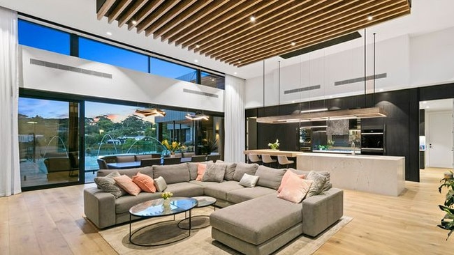 The open-plan family living and kitchen flows out to a terrace.