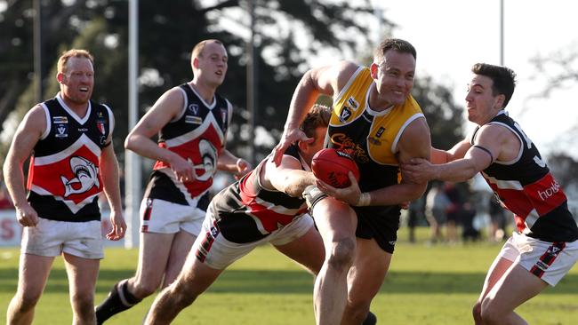 Ash Eames of YCW busts through a pack during the Peninsula League Grand Final between Frankston YCW and Bonbeach played at Kars Park in Frankston on Sunday 17th September, 2017. Picture: Mark Dadswell