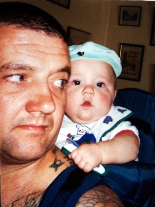 Crime Mark Chopper Read with his son Charles at 7 months old. Picture: supplied