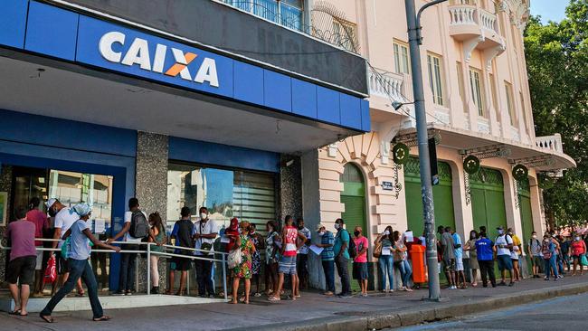 People queue in Rio de Janeiro to claim their government allowance. Picture: AFP