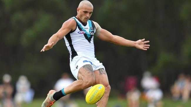 ON THE ATTACK: Sam Powell-Pepper boots Port Adelaide forward in the opening Marsh Community Series match against Brisbane in Queensland. Picture: DARREN ENGLAND (AAP).