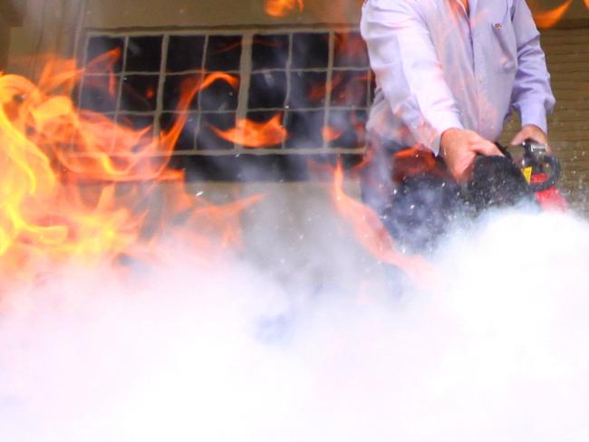 Morning Bulletin reporter Adrian Taylor during fire extinguisher training held for all Bulletin staff.   Photo Chris Ison / The Morning Bulletin   ROK020211-fire-c1