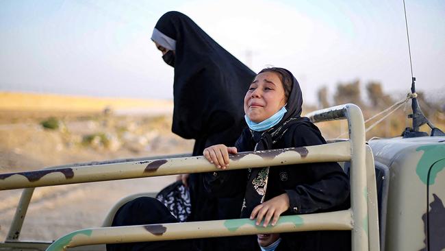 Afghan women and children on the back of a truck at the Iran-Afghanistan border between Afghanistan and the southeastern Iranian Sistan and Baluchestan province, as they try to enter the Islamic republic following the takeover of their country by the Taliban.