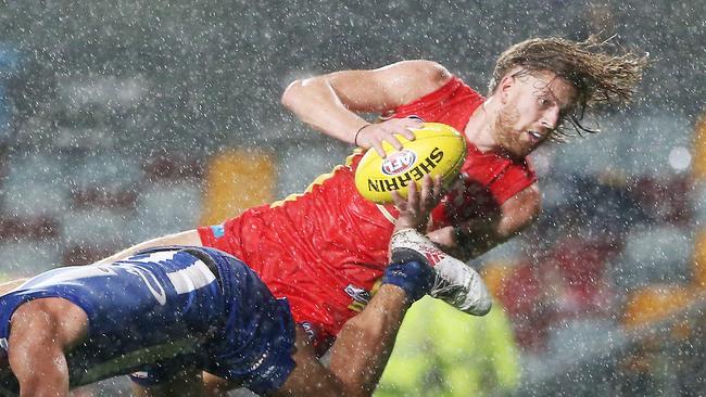 Action from the AFL match between the Gold Coast Suns and the North Melbourne Kangaroos, held at Cazalys Stadium, Cairns. Gold Coast's Aaron Young takes a spectacular mark. PICTURE: BRENDAN RADKE