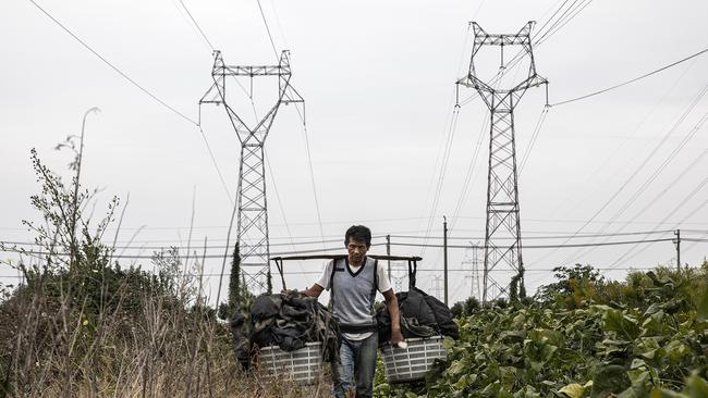 A farmer in Hubei province, China. China's electricity has been rationed in 12 provinces as the country grapples with energy shortfalls. Picture: Getty Images