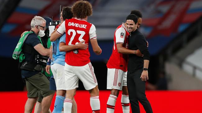 Mikel Arteta, far right, with his team after the game. Picture: AFP