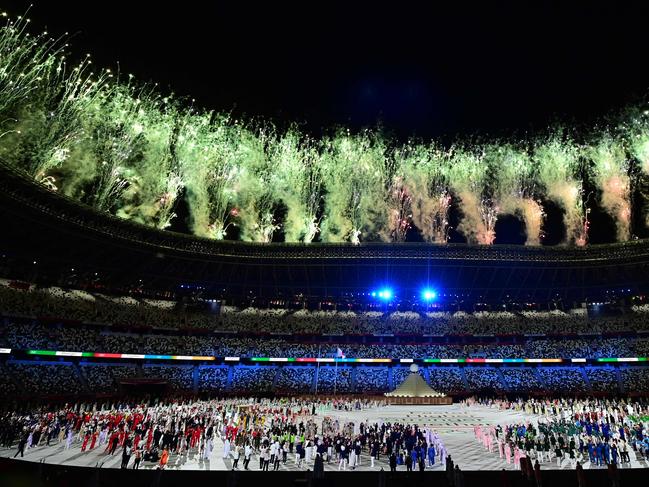 Fireworks erupt around the Olympic stadium.