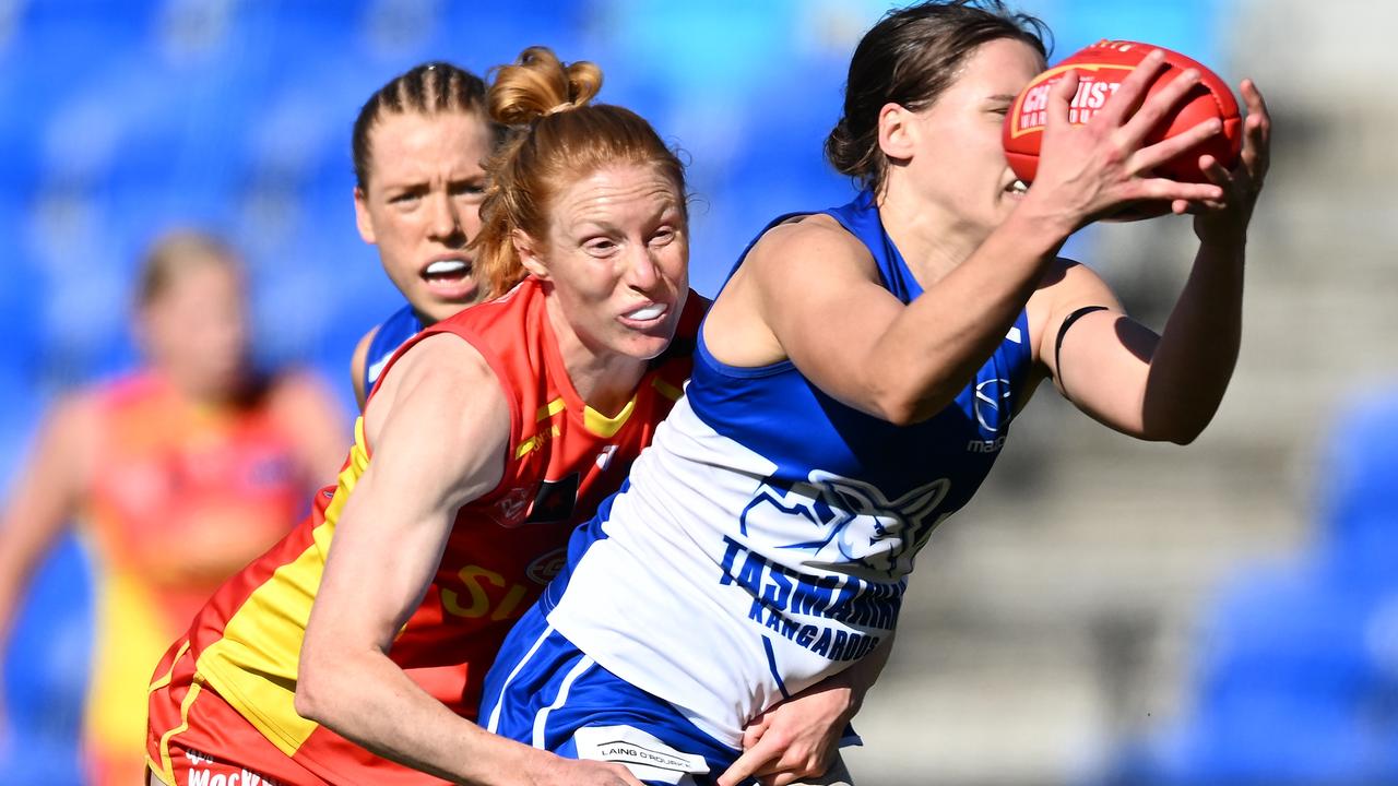 Jasmine Garner of the Kangaroos is tackled by Alison Drennan.