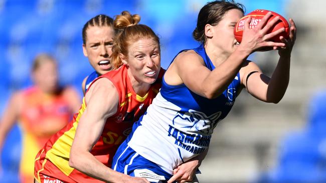 Jasmine Garner of the Kangaroos is tackled by Alison Drennan.