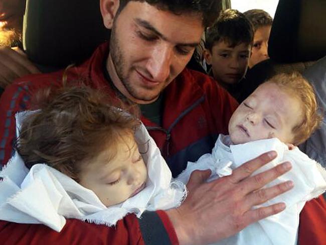 Abdul-Hamid Alyousef, 29, holds his twin babies who were killed during a suspected chemical weapons attack. Picture: Alaa Alyousef via AP