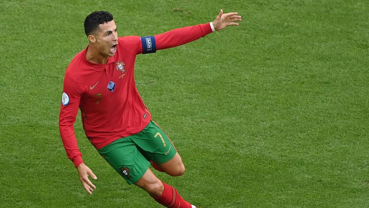 (FILES) In this file photo taken on June 19, 2021 Portugal's forward Cristiano Ronaldo celebrates scoring their first goal during the UEFA EURO 2020 Group F football match between Portugal and Germany at Allianz Arena in Munich on June 19, 2021. - Manchester United announced on Friday they have reached a deal to re-sign Cristiano Ronaldo from Juventus, 12 years after he left Old Trafford for Real Madrid. (Photo by Matthias Hangst / POOL / AFP)