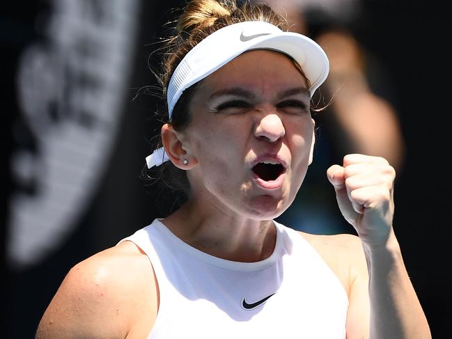 Romania's Simona Halep celebrates after beating Belgium's Elise Mertens during their women's singles match on day eight of the Australian Open tennis tournament in Melbourne on January 27, 2020. (Photo by William WEST / AFP) / IMAGE RESTRICTED TO EDITORIAL USE - STRICTLY NO COMMERCIAL USE