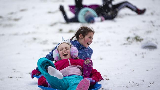 ‘They are having fun and not even talking’: youngsters sled down the west side of the US Capitol yesterday. Picture: Getty Images