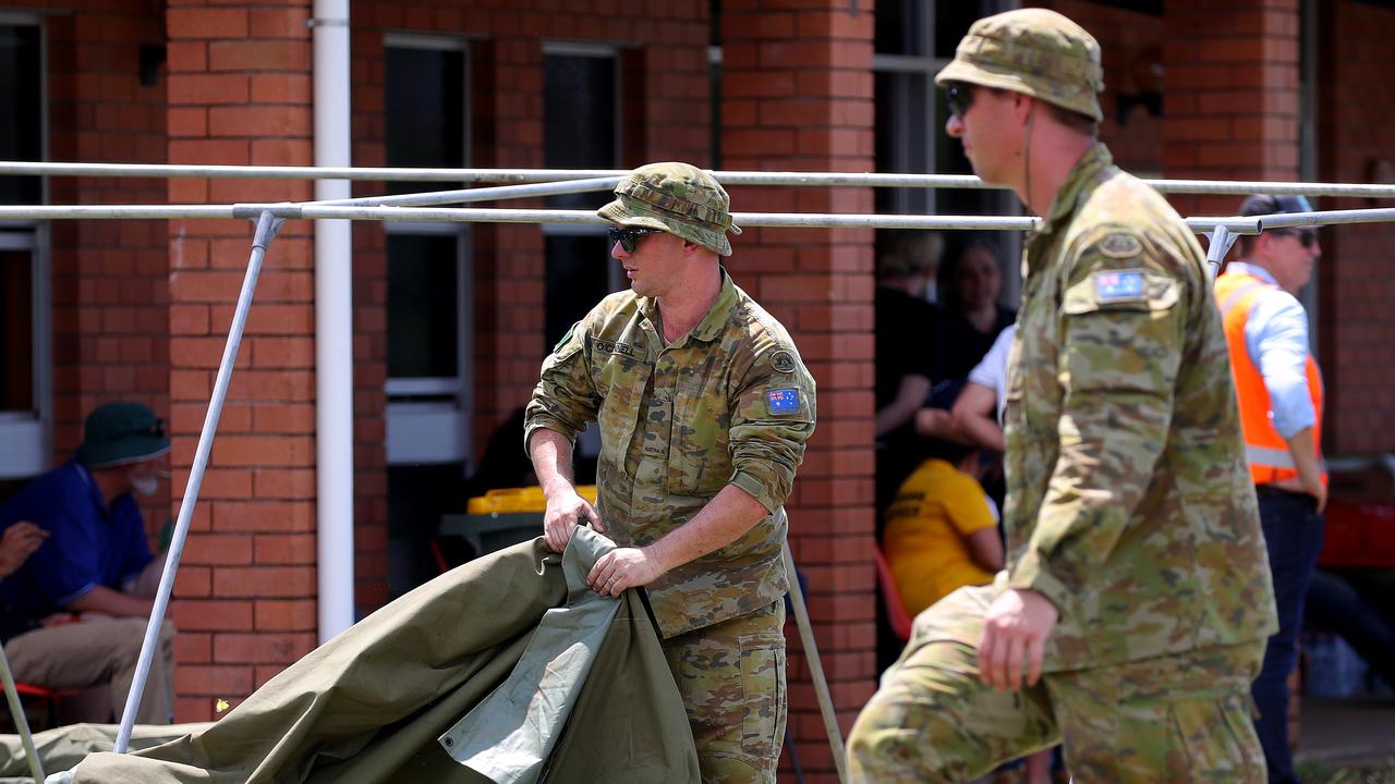 Members of the ADF assist in the clean-up in Lismore. Picture: Toby Zerna