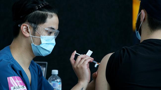 A nurse administers a Covid-19 vaccine to a person in Lakemba. Picture: Getty Images