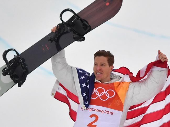 (FILES) In this file photo taken on February 14, 2018 US Shaun White celebrates on the podium during the victory ceremony after the final of the men's snowboard halfpipe at the Phoenix Park during the Pyeongchang 2018 Winter Olympic Games on February 14, 2018 in Pyeongchang. - American snowboard legend Shaun White said on February 5, 2022 he will retire from competition after he attempts to defend his Olympic title in Beijing, citing the "little signs" from his 35-year-old body. The three-time halfpipe champion said he intends to "squeeze every bit of fun and excitement" out of his fifth and final Games before bringing the curtain down on his storied career. "In my mind, I think I've decided this will be the last competition," said the man who has done more than anyone to bring snowboarding to the world's attention. (Photo by Martin BUREAU / AFP)