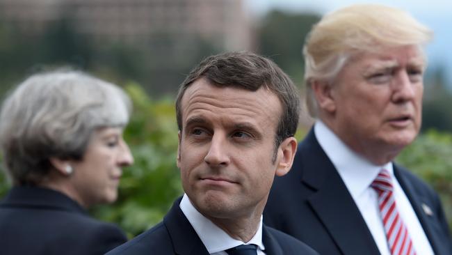 (L-R) Britain's Prime Minister Theresa May, French President Emmanuel Macron and US President Donald Trump attend the Summit of the Heads of State and of Government of the G7.