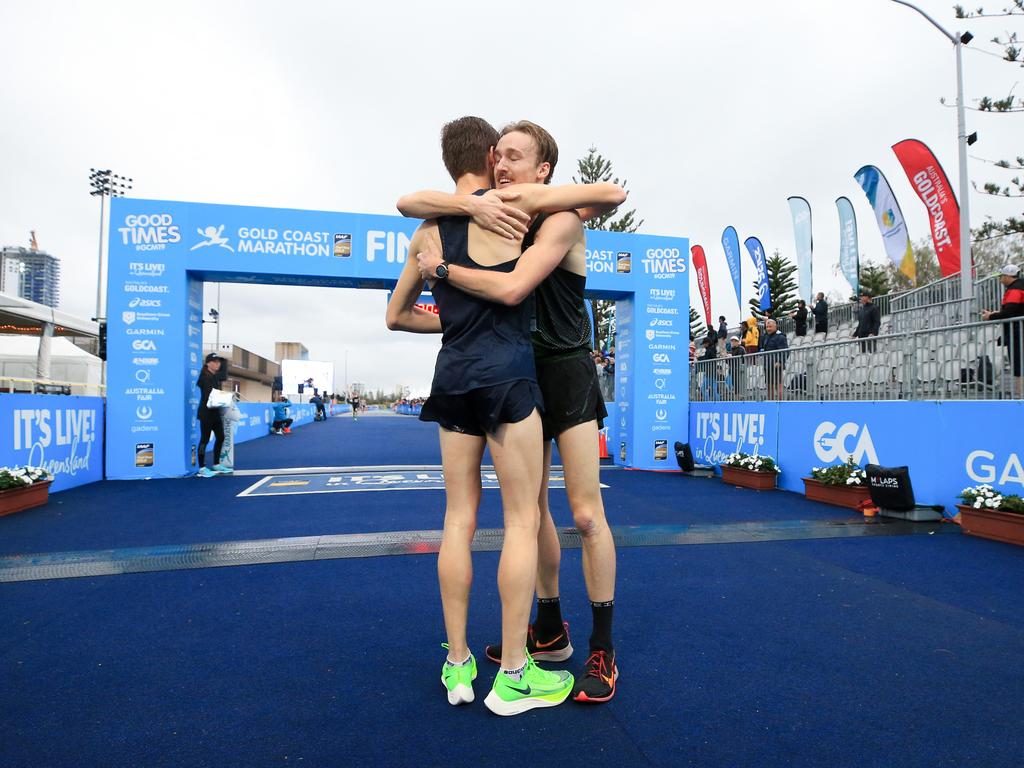 Lachlan Barber (right) congratulates second place getter Tim Vincent at the finish line of the Southern Cross University ten kilometre Run. Picture: Tim Marsden.