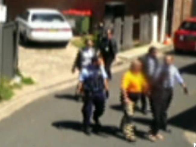 The teen is led away by police to be taken to Bankstown Police Station. Picture: Seven News