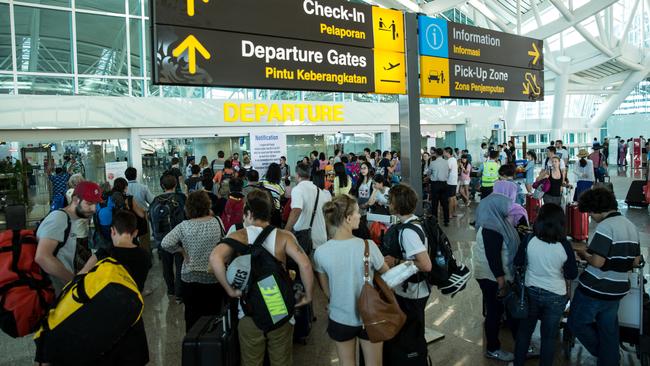 Foreign tourists seeking flight information at Ngurah Rai Airport in Denpasar, during the volcanic ash delays last July. Picture: Agung Parameswara/Getty Images