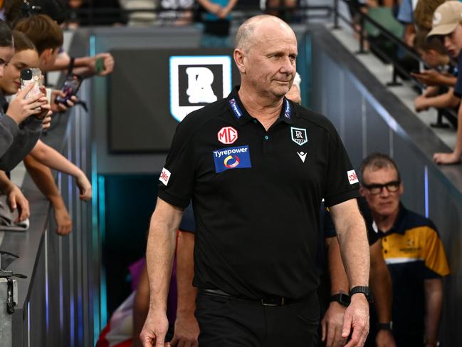 MELBOURNE, AUSTRALIA - MARCH 15: Ken Hinkley the coach of Port walks out onto the field during the round one AFL match between Collingwood Magpies and Port Adelaide Power at Melbourne Cricket Ground, on March 15, 2025, in Melbourne, Australia. (Photo by Quinn Rooney/Getty Images)