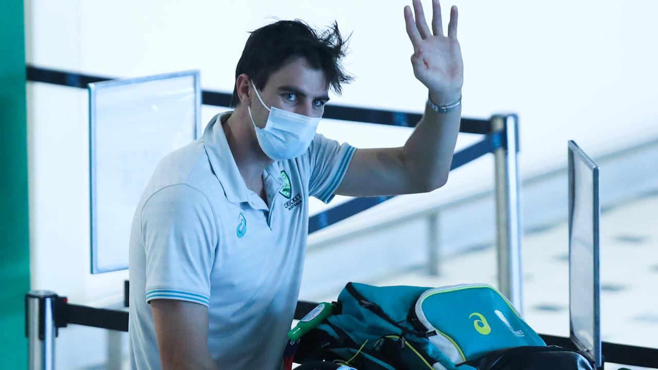 Pat Cummins waves as the Australian T20 cricket team arrive at Brisbane International Airport after their World Cup win in Dubai. Picture: Zak Simmonds