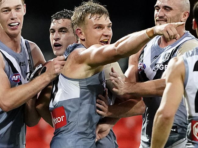 Ollie Wines of the Power (3L) reacts after kicking a goal during the Round 3 AFL match between the Fremantle Dockers and the Port Adelaide Power at Metricon Stadium on the Gold Coast, Sunday, June 21, 2020. (AAP Image/Dave Hunt) NO ARCHIVING, EDITORIAL USE ONLY