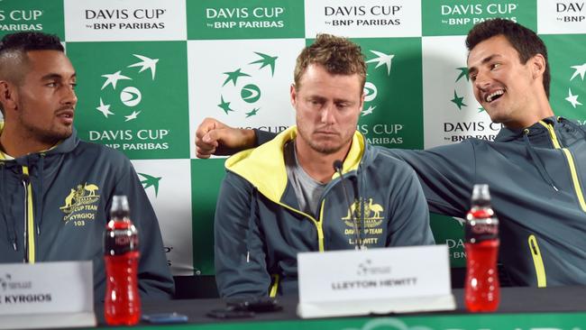 Australia's Nick Kyrgios (L) and Bernard Tomic (R) joke about when asked about their relationship as Davis Cup captain Lleyton Hewitt (C) looks on. Picture: AFP