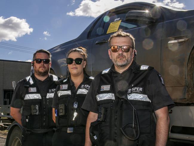 SPER enforcement team leader Daniel Armstong (centre) with agents David Lyon and Emma Love standing with a vehicle they seized in Kingaroy for outstanding SPER debts. Picture: Dominic Elsome