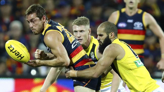 Adelaide’s Richard Douglas under pressure from Richmond’s Bachar Houli. Picture: Sarah Reed