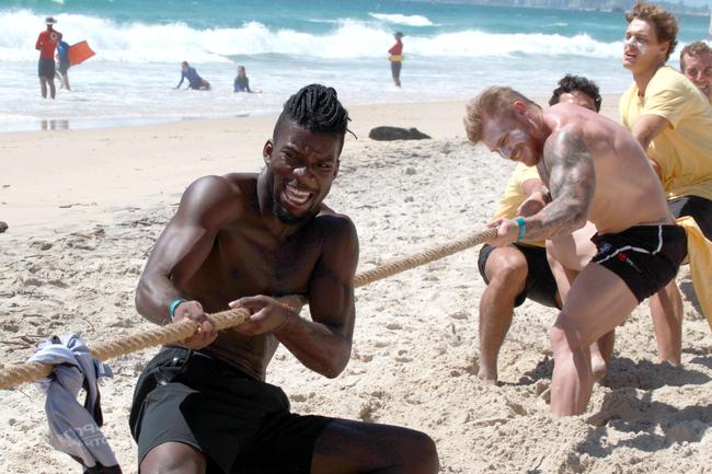 Kwabe Boakye (front left) in the midst of a tug-of-war battle during the Southport Sharks VFL team during a preseason training camp at Tallebudgera Beach. Picture: Mike Batterham