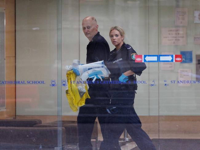 Officers remove items from the school on Thursday morning. Picture: NCA NewsWire / David Swift