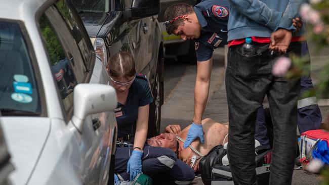 Paramedics treat John after his heroin overdose. Picture: Jason Edwards