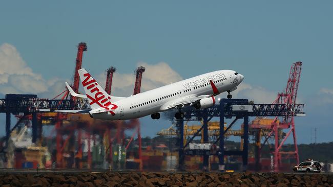 A Virgin Australia airline takes off at Sydney Airport in Sydney, Australia, on Friday, December. 6, 2013. Picture: Brendon Thorne/Bloomberg