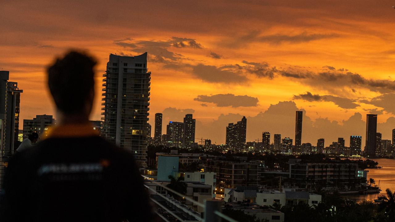 Australian McLaren driver Daniel Ricciardo watches the sunset