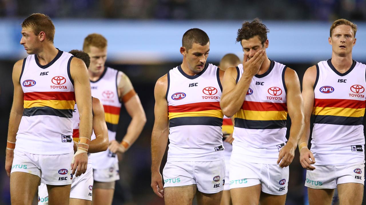 Adelaide players walk from the ground after their loss to North Melbourne. Photo: Scott Barbour/Getty Images.