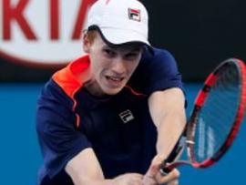 Jake Delaney plays a shot in the 2015 Australian Open boys’ doubles championship match.